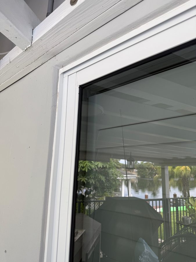 Frame and trim — mud dauber nest and webbing cleared from the jamb beside the glass. after