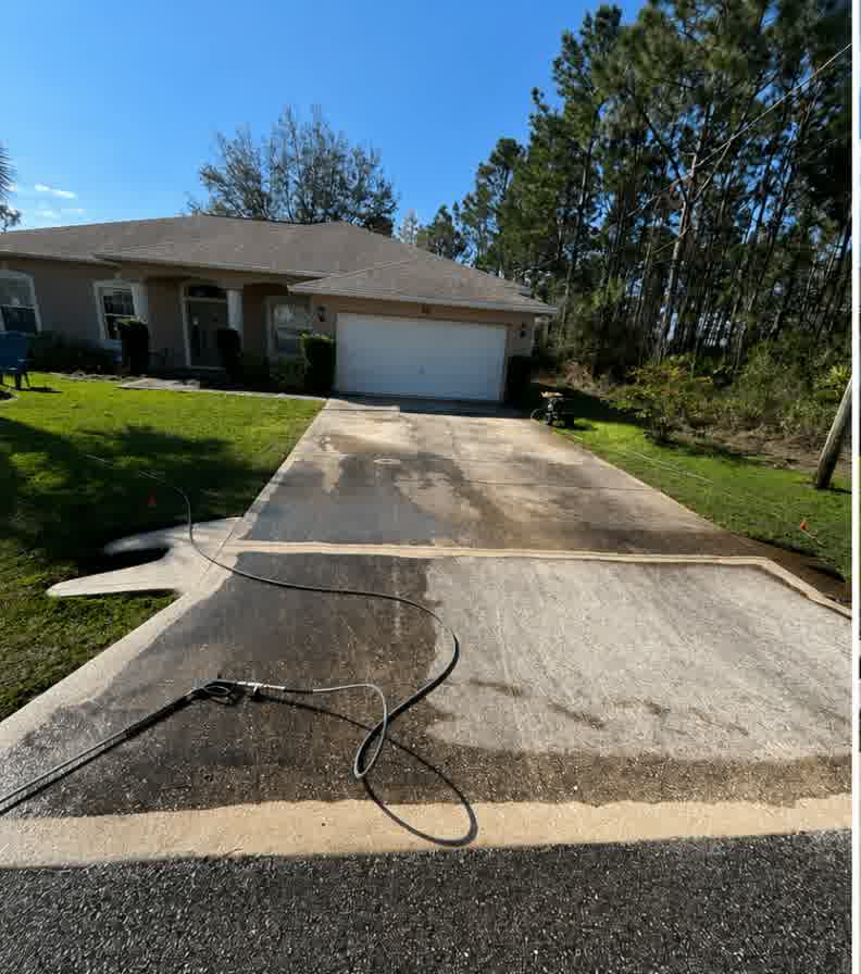 Driveway — cleaning worked across the slabs, then rinsed to an even finish. in progress