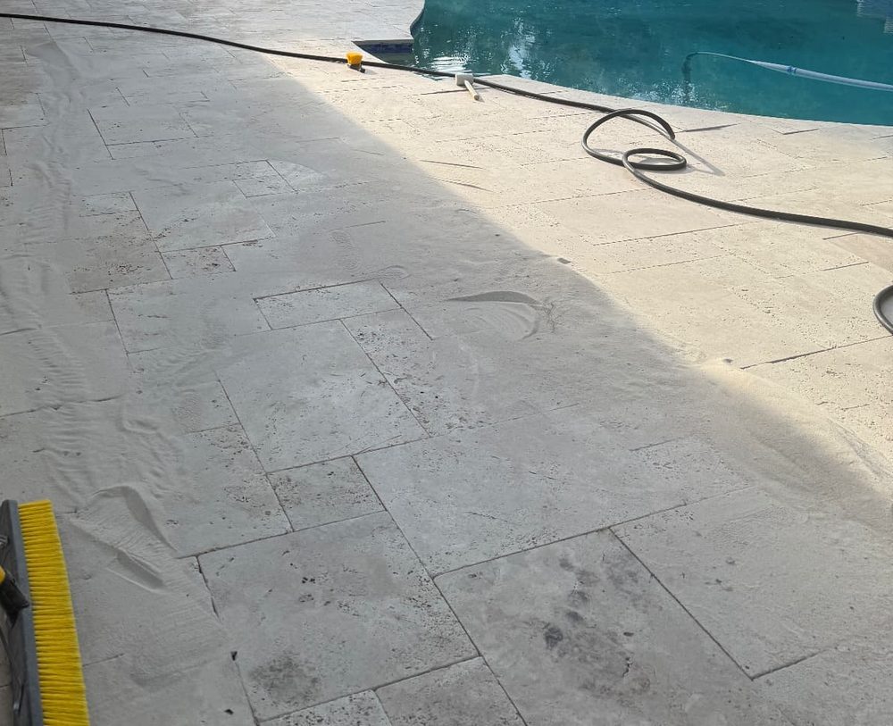 Polymeric sand swept across the cleaned deck to fill the joints before hardening. joint sand